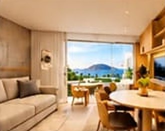 Perspectiva da sala de um apartamento de 1 quarto com vista para o mar
